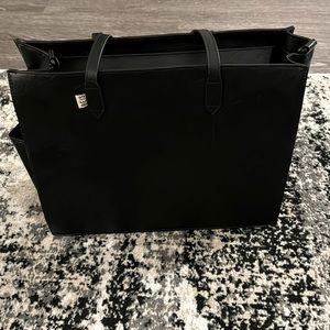 Black Beis bag. Multiple zips and pockets with a water bottle holder on the side